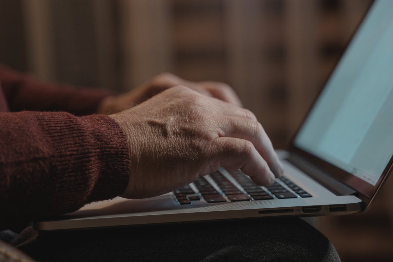 Services Close-up of hands typing on a laptop keyboard, ideal for business and technology themes.